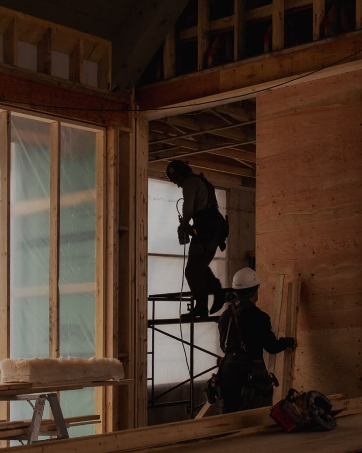 Builders framing a residential extension on site